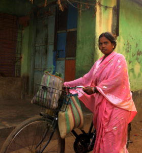 Village woman cycling in Amadpur